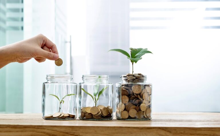 Why I’m Adding to This Dividend Stock Right Now jar with coins and plant