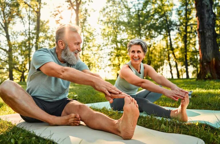 2 TSX Dividend Stocks Retirees Can Buy and Hold for the Next Decade senior man and woman stretch their legs on yoga mats outside