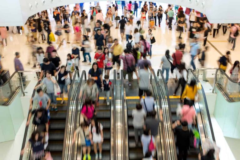 A Top-Notch 5.5% Dividend Stock Paying Cash Every Month in Retirement shoppers in an indoor mall