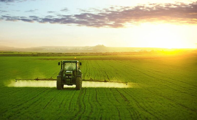B.C.’s Premier-Elect Wants to Double Gas Output: This Vancouver Stock Sells the Equipment Tractor spraying a field of wheat with fertilizer