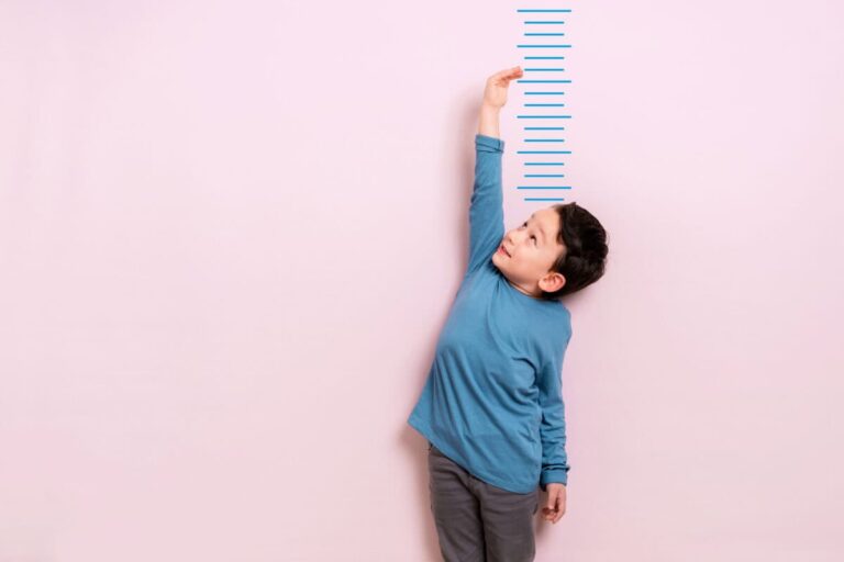 Down 16% and Paying 5.8%: The Case for Buying Enbridge Now Child measures his height on wall. He is growing taller.